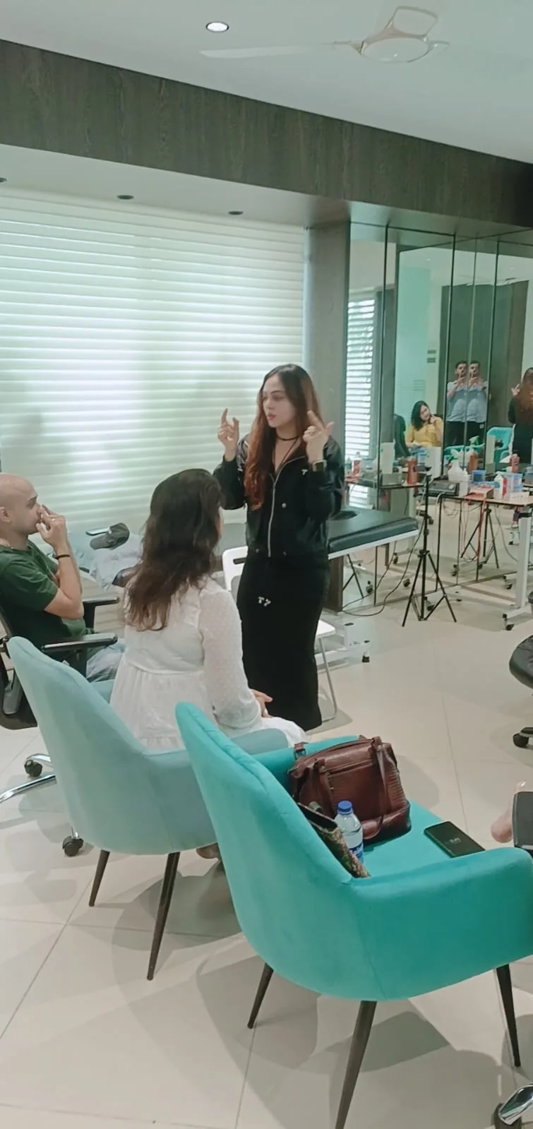 Vibha Jain in her practice space, speaking with clients during a session