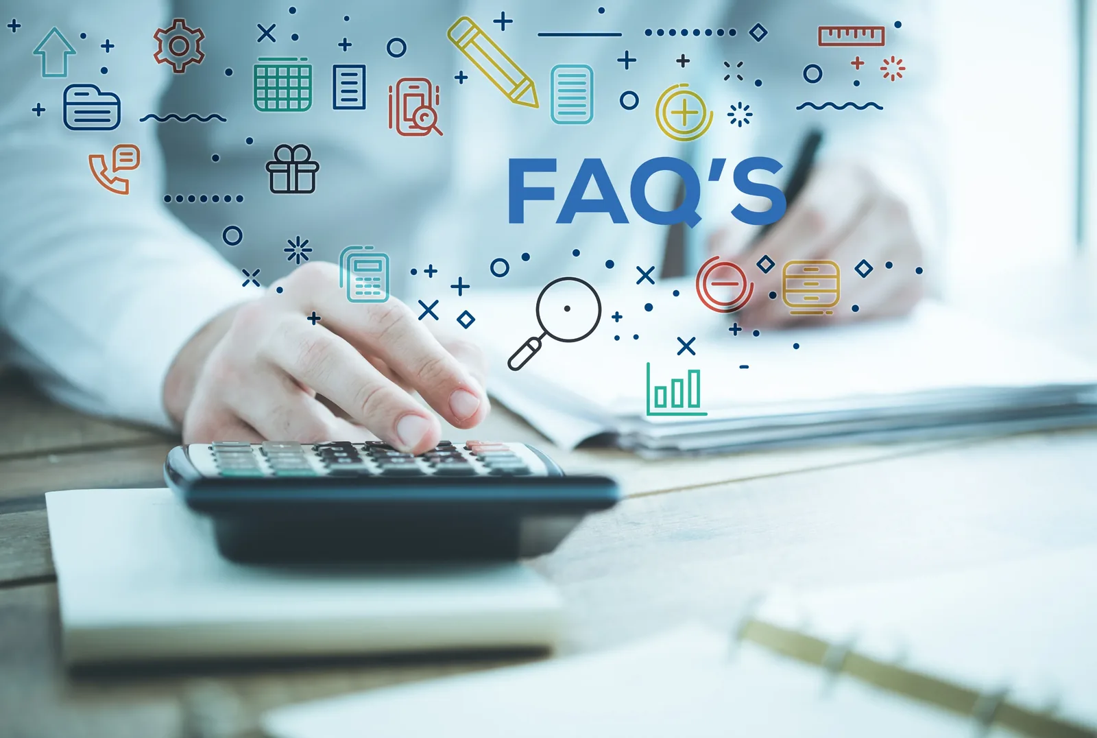 An illustration of frequently asked questions displayed above a desk with notes and a calculator