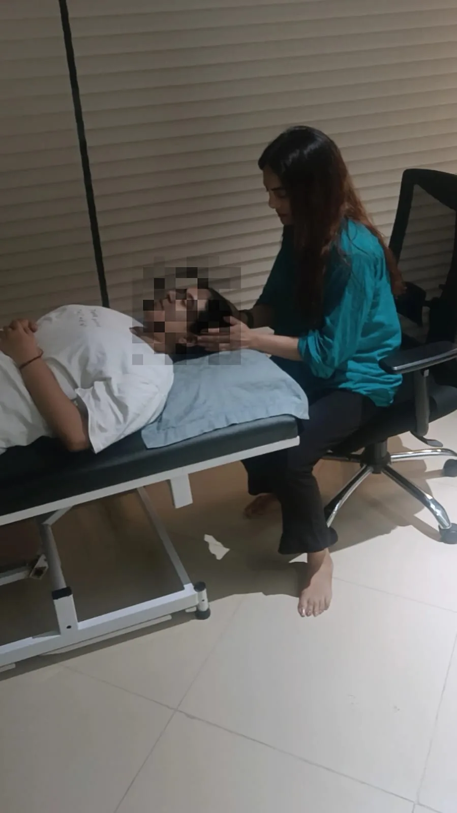 A client resting in a relaxed position during the guided relaxation stage of a hypnotherapy session